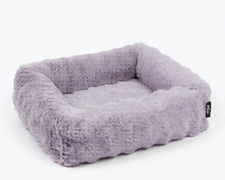 The Bliss Bed in Petal — a blush-pink bolster bed in deep, plush faux fur.
